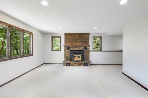 The family room is very large at 19' x 15' in size. This walkout room features windows that offer fantastic backyard views, a wood burning fireplace wrapped in brick and a wetbar area (not shown in photo).