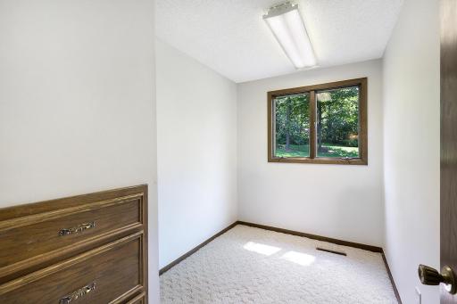 The home office is a private productive space with a window view of a great natural setting and the front yard.