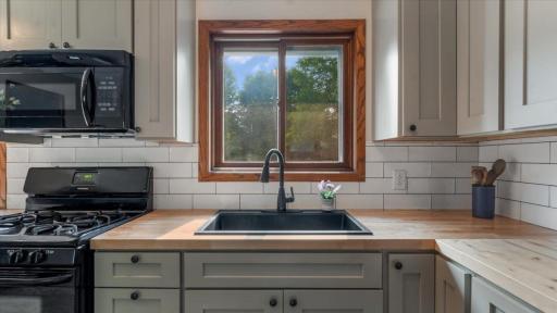 Beautiful updated kitchen with new cabinets, butcher block countertops, backsplash and more.jpg