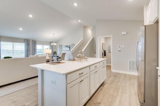Extremely open and inviting, this main level is great for hosting or hanging out! Staged model photograph, some options and colors may vary.