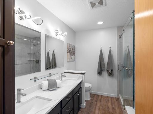 Newer tiled shower with custom glass sliding door.