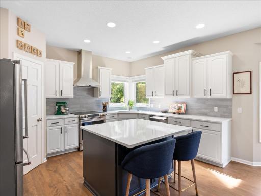 Bright, functional kitchen opens seamlessly to the dining area and deck, ideal for entertaining.