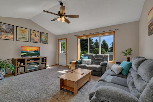 Living Room with Vaulted Ceiling, Allowing Natural Light to Pour In