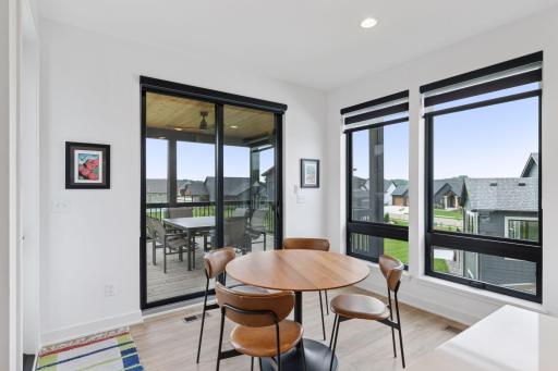 Breakfast nook with a view into screened porch