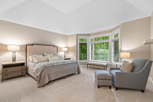 Retreat to your primary suite with peaceful views and luxurious comfort.