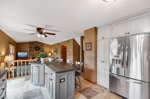Note the full height pantry with pull out shelving and all the deep storage cabinets above.