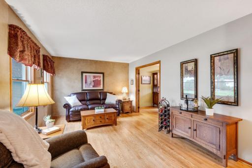 The main floor living room is large and welcoming with oak hardwood flooring and is open to the foyer and the dining room.