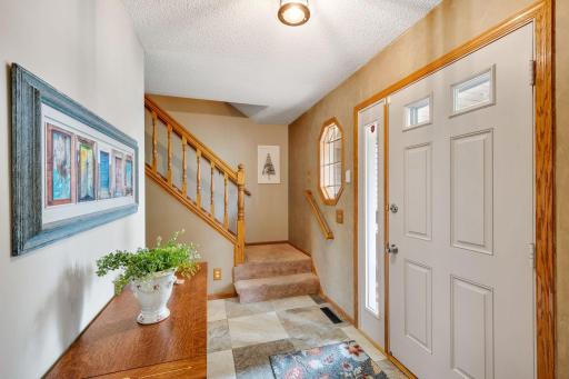 The generous foyer greet guests in style - note the newer large format ceramic tile floors!