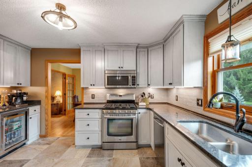 The 5 burner gas range and wine/coffee bar elevate the space.