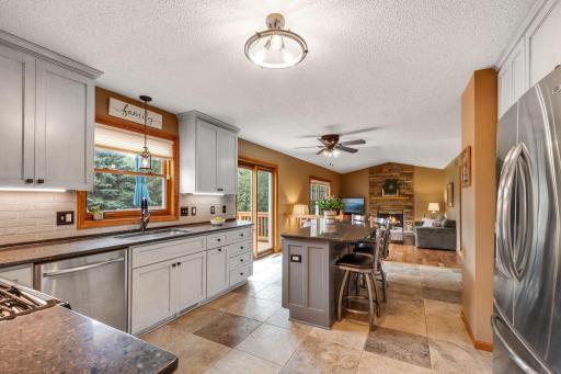 This kitchen has all the updates completed around 2018 with new tile flooring, cabinetry, tile backspace, silestone counters, suite of Maytag stainless appliances, a great center island/breakfast bar and MORE!