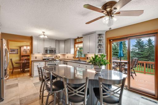 View of the island which comfortably seats 4 with nearby sliding doors to the sunny, south facing deck.
