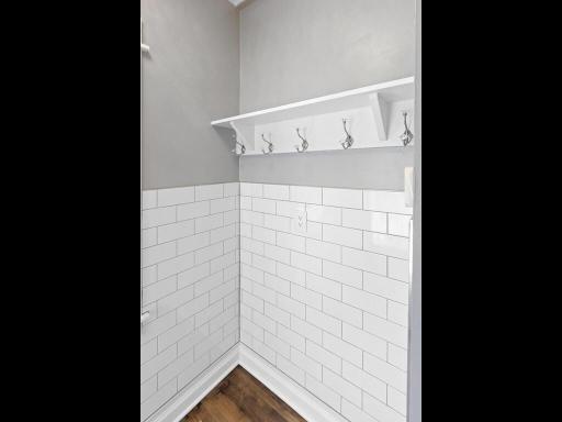 The chic subway tile continues into the back entry/mudroom area