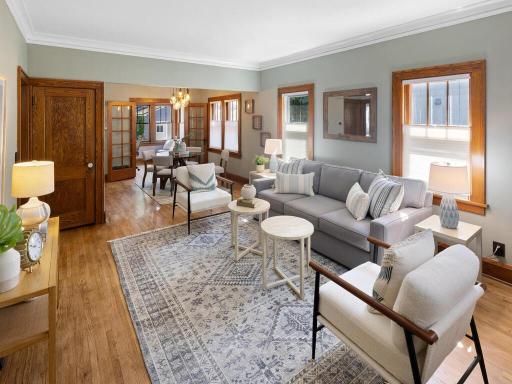Another view of the living room shows the beautiful woodwork and the flow into the dining room