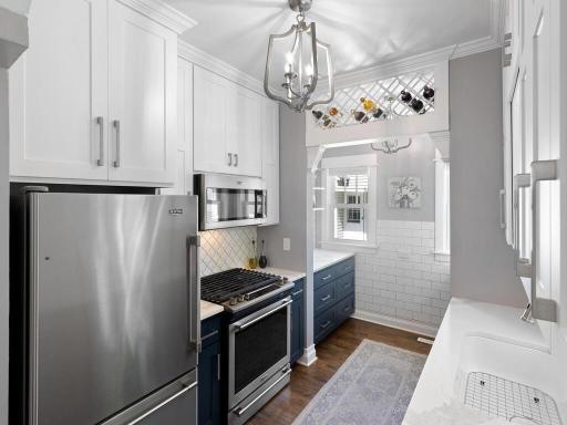 The kitchen features quartz counter tops and leads into a bonus pantry and prepping area!