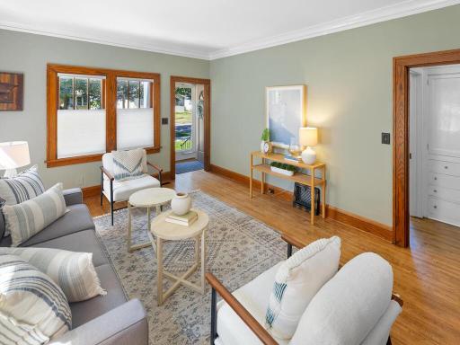 The living room as you enter the home features freshly refinished hardwood floors and tremendous natural light