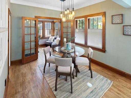 The dining room features a custom chandelier and french doors into the office space/play room