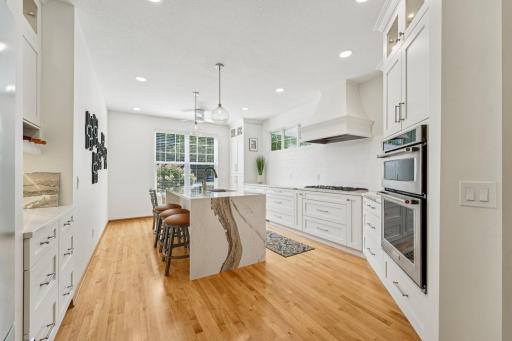 Wonderfully updated kitchen with Cambria waterfall kitchen island