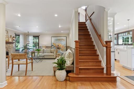 A stunning cherrywood staircase anchors the main level, leading gracefully to the second floor with timeless craftsmanship and architectural charm