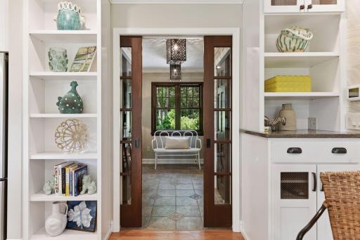 Mudroom accessed through dual window-paned sliding doors, offering a stylish and functional transition space with clear sightlines to adjoining areas