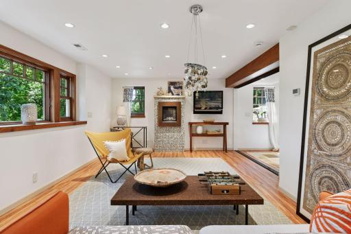 Lower-level family room with gas fireplace, recessed lighting, and abundant natural light