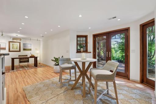 Lower-level family room flows into a flexible seating and office area, with French doors opening to the backyard