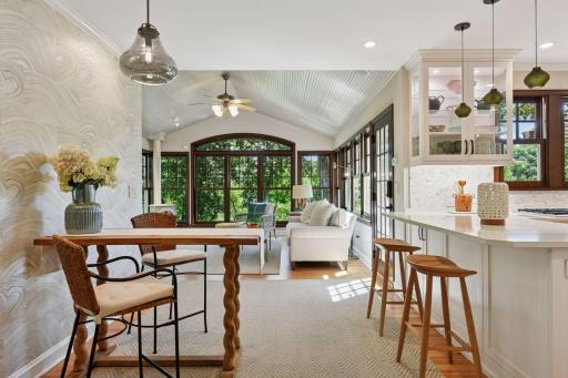 Charming breakfast nook offers a warm retreat with views into the bright and airy sunroom