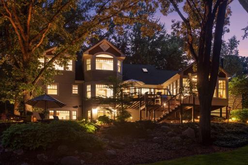 At twilight, the tiered deck glows with warmth from the home's expansive windows