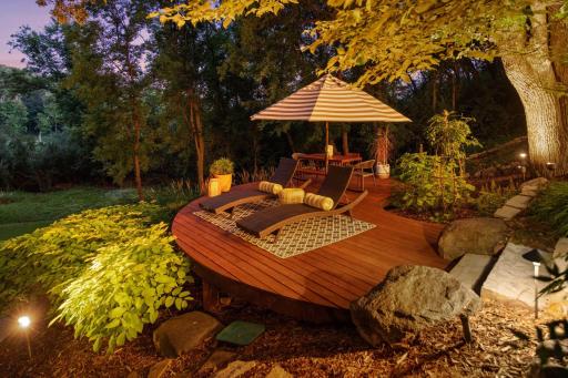 As night falls, the softly lit circular deck invites quiet moments