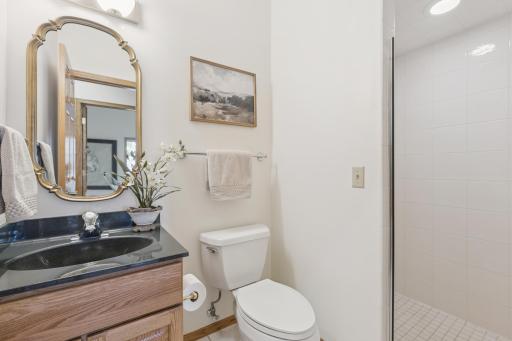 Just off the main floor living room is a three-quarter guest bath with walk-in tile shower.