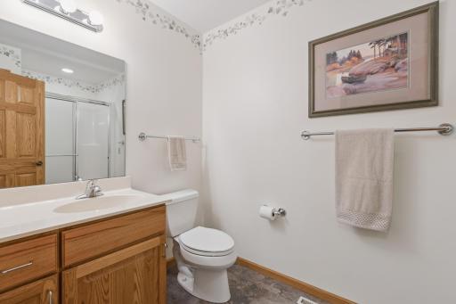 As you enter from the attached garage and proceed through the mudroom there is a three-quarter bath. Perfect for cleaning up following yard work or working in the garage.