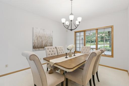 View of the formal dining room located between the kitchen and the foyer. This dining space can easily accommodate seating for 10-12, ready for dinner parties or hosting holidays with family and friends at Lake Pulaski.