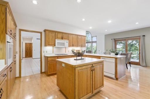 The spacious kitchen offers an open design with peninsula and center island. Providing plenty of preparation space and storage. You will also appreciate the timeless hardwood floors and tile throughout the high traffic areas of the main floor.