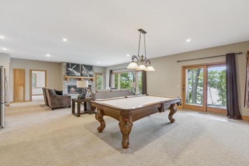As we proceed to the walk-out lower level of the home you will love the open design and the continuance of oversized windows looking out over Lake Pulaski.