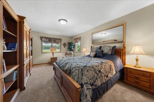 Private ownerâs suite with a walk-in closet and an ensuite bath offering a jetted tub and walk-in shower.
