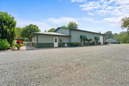 An expansive retreat building provides added versatility. Thoughtful storage solutions provide convenience with a 23x29 storage space attached to this building featuring a 12ft door, plus an additional 26x26 fully insulated and heated outbuilding.