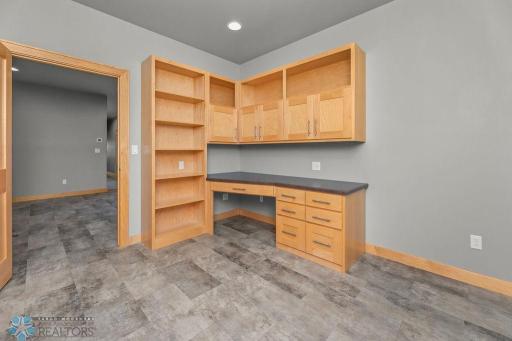 Currently styled as an office, Bedroom 3 features built-in desk, drawers, and shelves plus a storage closet.