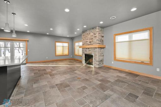 Living Room w/ recessed lighting, large windows, gas fireplace.