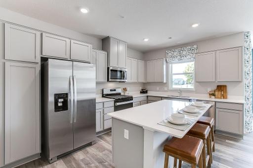 Welcome Home to The Harlow! Similar kitchen layout, home will feature a built in island. Kitchen window will be excluded. Photo of a similar layout model home, layout and colors will vary.