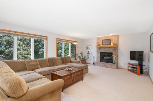 Main floor Family Room with wood burning fireplace overlooks the backyard