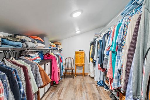 A walk-in closet emphasizes tidiness with storage solutions for all your clothes and accessories.