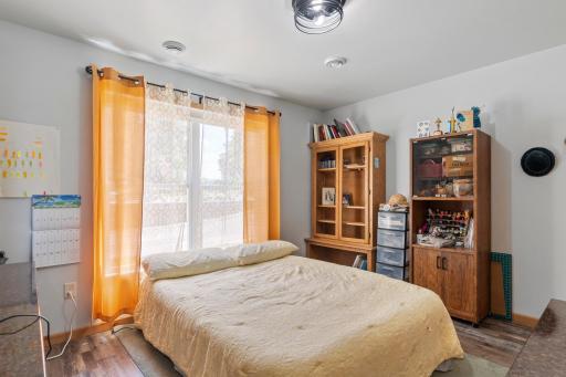 The second bedroom also features a neutral palette and large window. Perfect for a guest bedroom, at home office, and more!