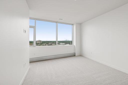 Spacious enough for a king bed, the primary bedroom feels like a private escape surrounded by skyline lights and endless views.