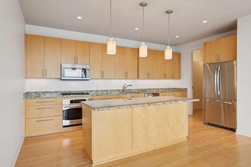 A spacious center island with breakfast bar seating makes casual dining easy and gatherings effortless.