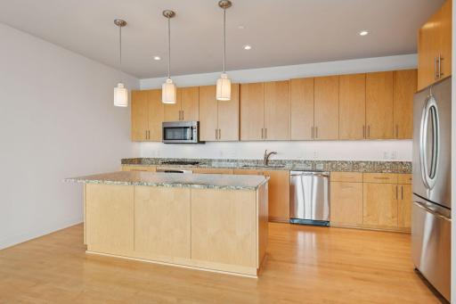 Abundant cabinetry and granite countertops provide generous storage and prep space for any culinary adventure.