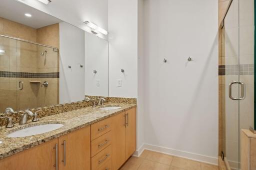 A spacious double vanity offers sleek functionality and ample storageâideal for effortless mornings.