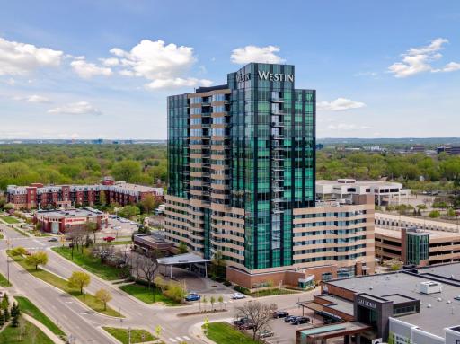 Unit 1404 is located in the center of the building's north face, directly above the hotel entrance canopy and just above the horizon line in this photo. Also note the dedicated resident lobby/entrance location in the lower right of this photo