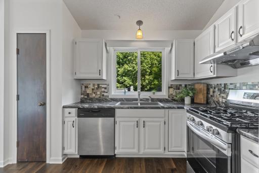 A Bright And Cheery Kitchen With A Lovely View Of The Backyard