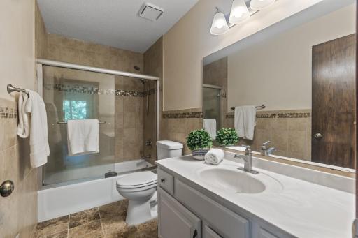 Upper Level Bathroom With Tile And Glass Sliding Door