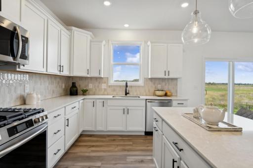 (Photo of a decorated model, actual homes finishes will vary) Another view of the kitchen.
