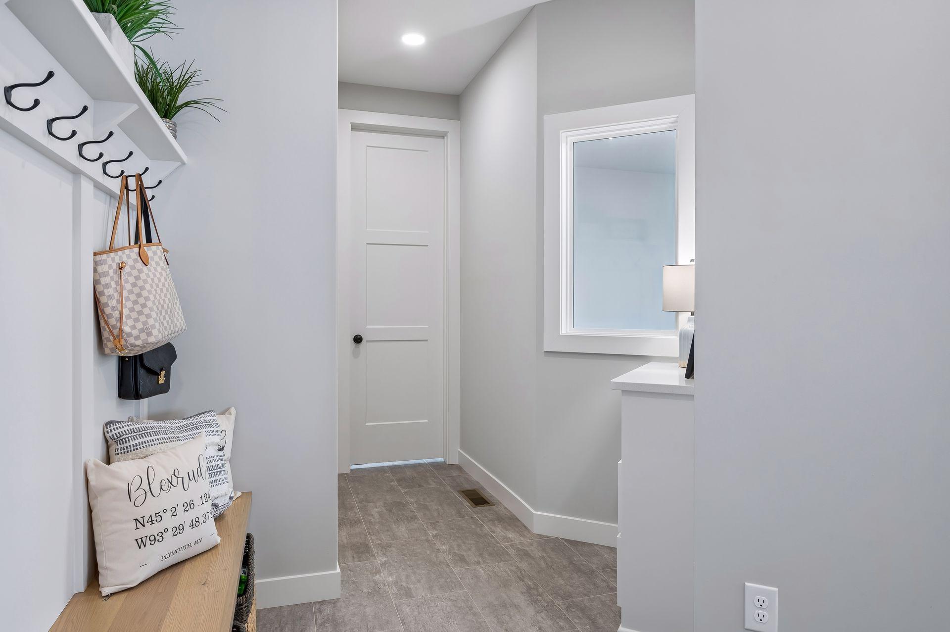 Hallway to main level bath with window over sport court